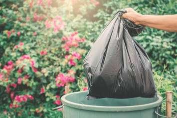 A garbage bag gets thrown out. 