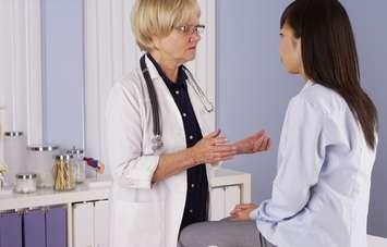 A doctor speaks with a patient. File photo courtesy of © Can Stock Photo / rocketclips