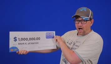 Mark Keltika of Harrow shows off his million-dollar cheque at the OLG Prize Centre in Toronto. Photo courtesy Ontario Lottery and Gaming.