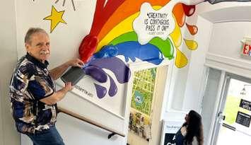 Arts donor and supporter Merv Redman, of Kitchener, has fun with a new interactive mural in the foyer of the Southampton Art Gallery, on High St. in Southampton. Photo from Community Foundation Grey Bruce
