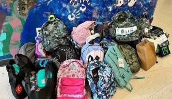 Donations of fully stocked backpacks made during the Stuff-A-Bus event at Grant's Your Independent Grocer in Hanover, August 25, 2024. Photo provided by United Way Bruce Grey
